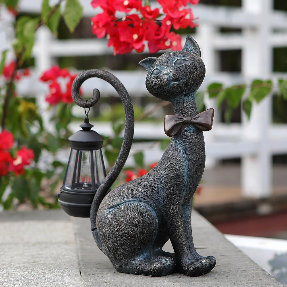 Front view of REYISO Cat Outdoor Statue with solar lantern, bronze finish