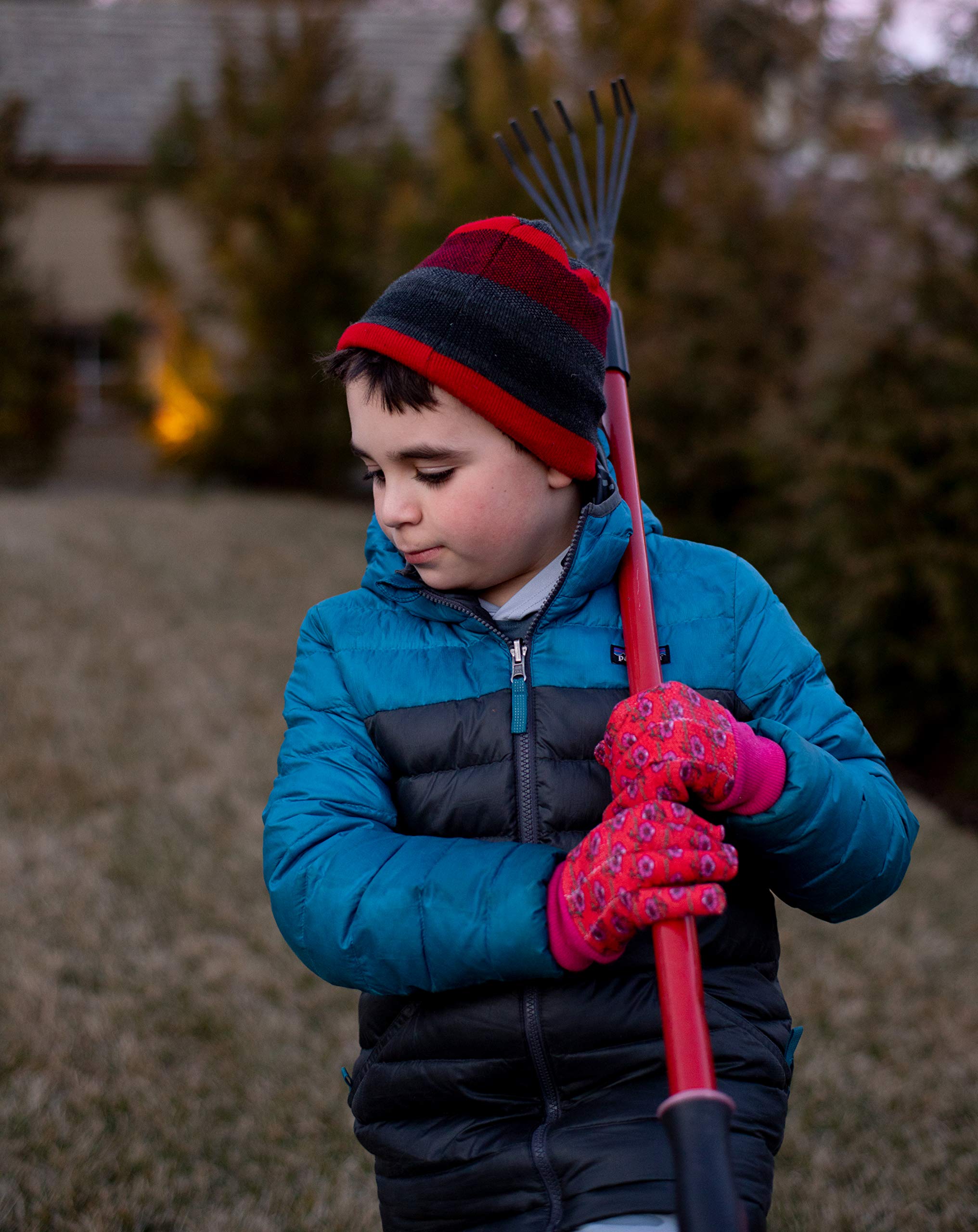 G & F Kids Garden Gloves laid flat on a garden background