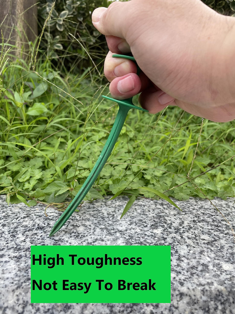 Garden hose guide stake in use with hose
