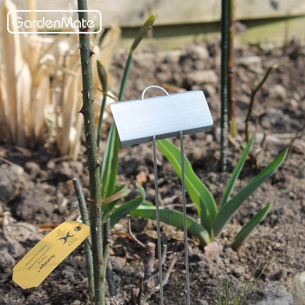 GardenMate 11.5 inch metal plant label next to a flower pot