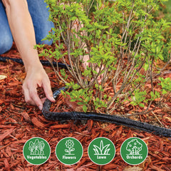 GILMOUR Flat Soaker Hose in a garden bed watering plants