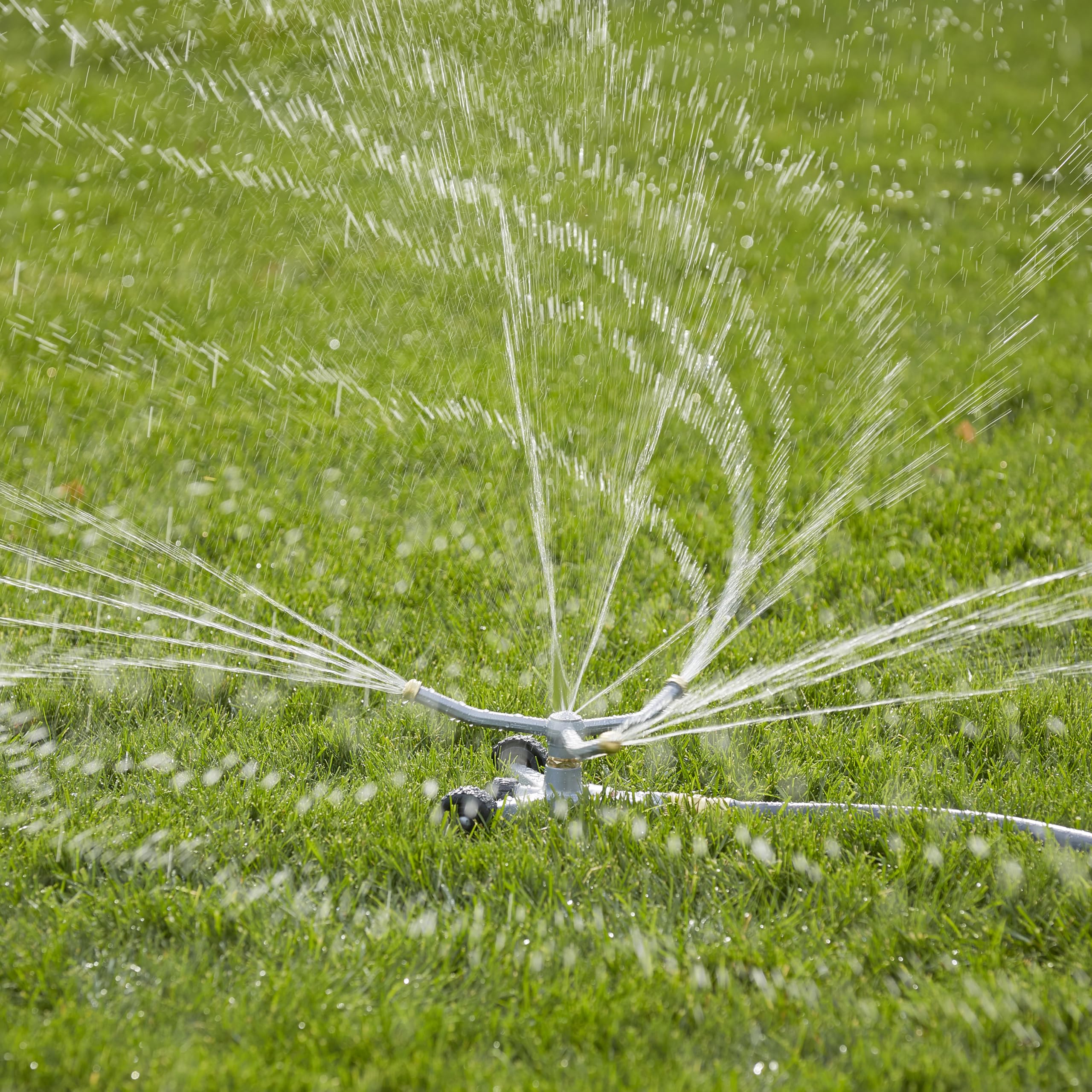 GILMOUR Heavy Duty Sprinkler in use watering flower beds