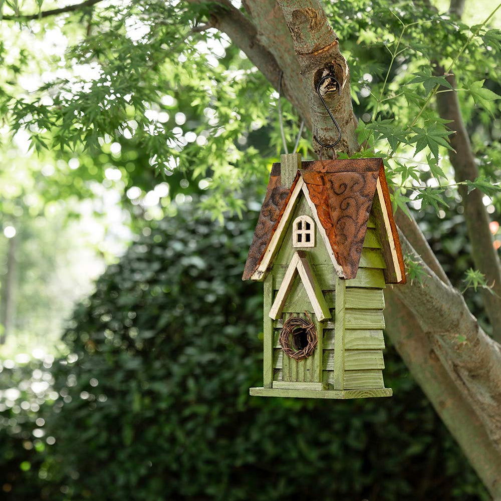 Glitzhome decorative birdhouse in a garden setting
