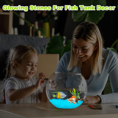 Glow in the dark pebbles scattered in a fish tank