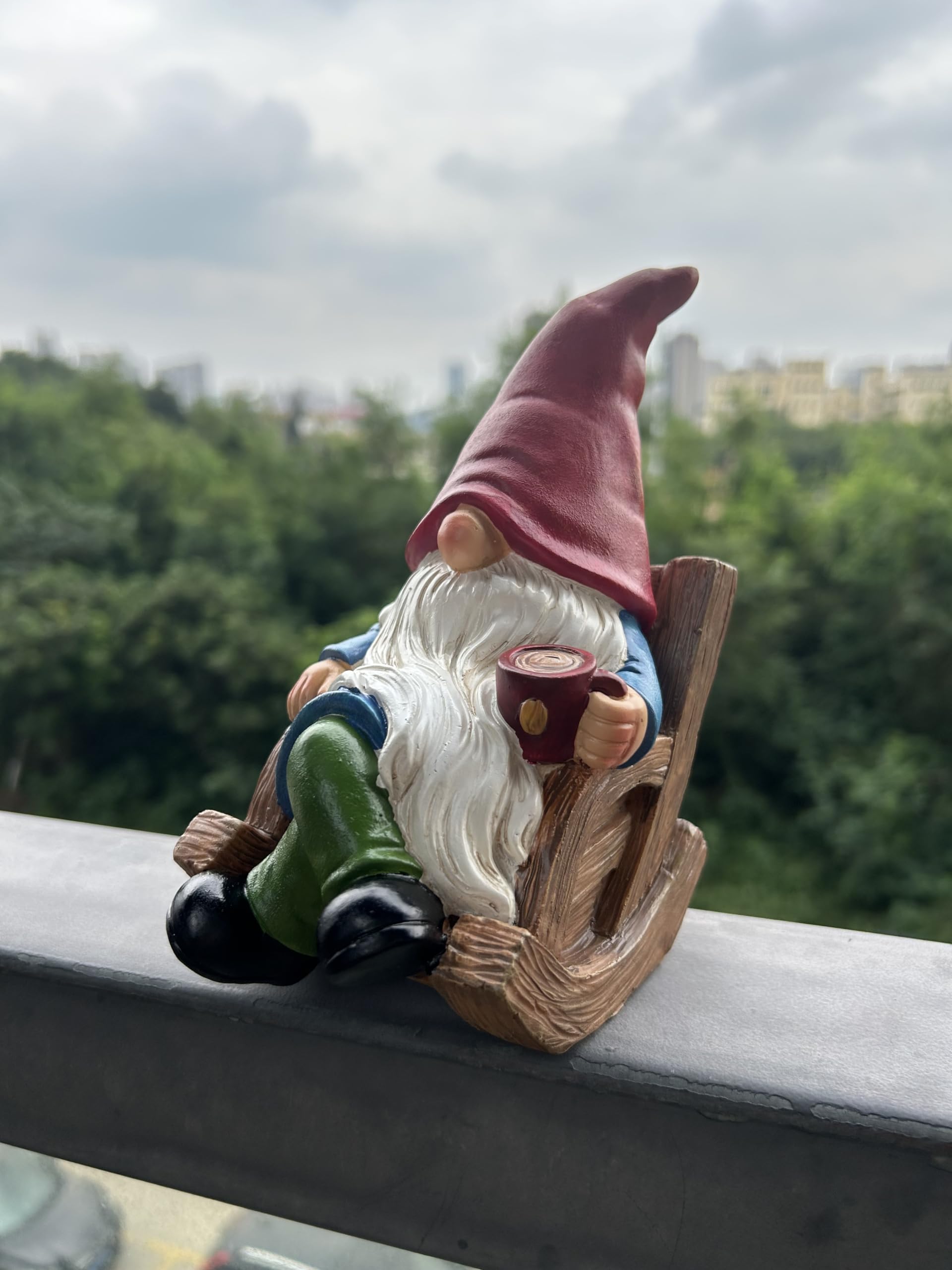 Gnome statue in a flower bed among blooming flowers