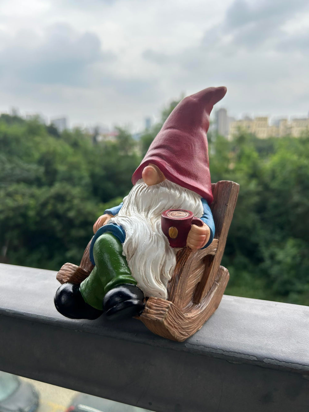 Gnome statue in a flower bed among blooming flowers