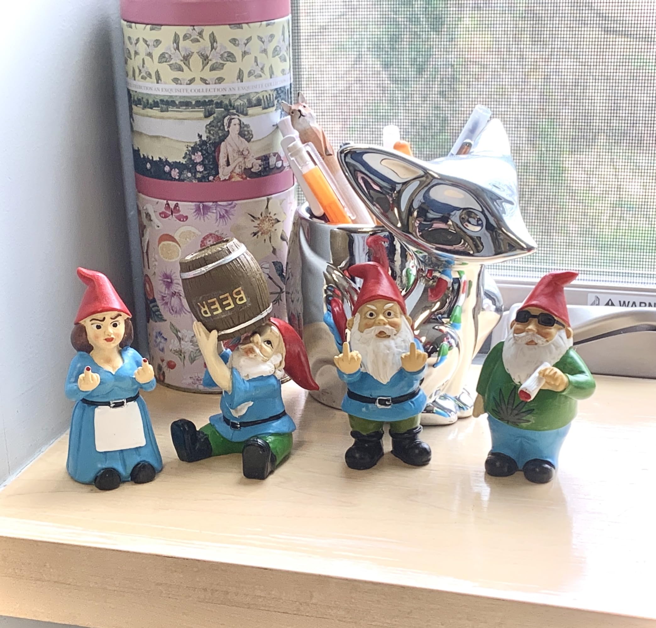 Gnometastic Mini Middle Finger Gnome next to flower pot