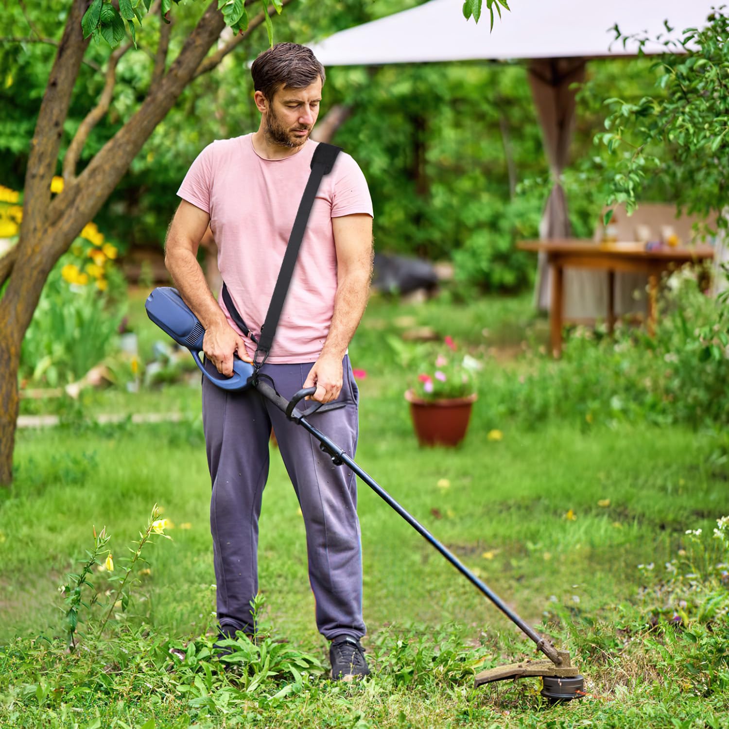GodFan Trimmer Strap attached to a string trimmer