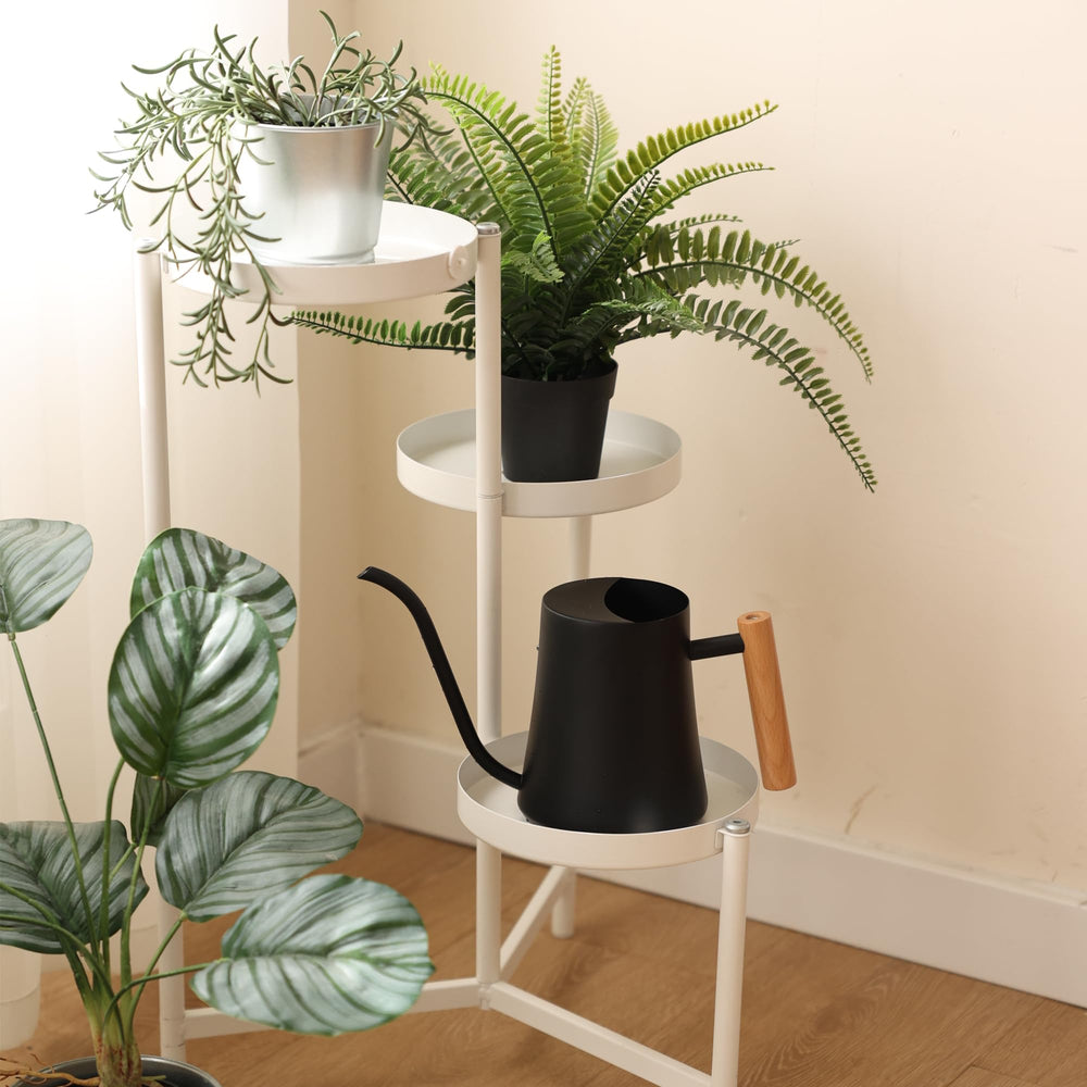 Green Moon Watering Can with plants on a table