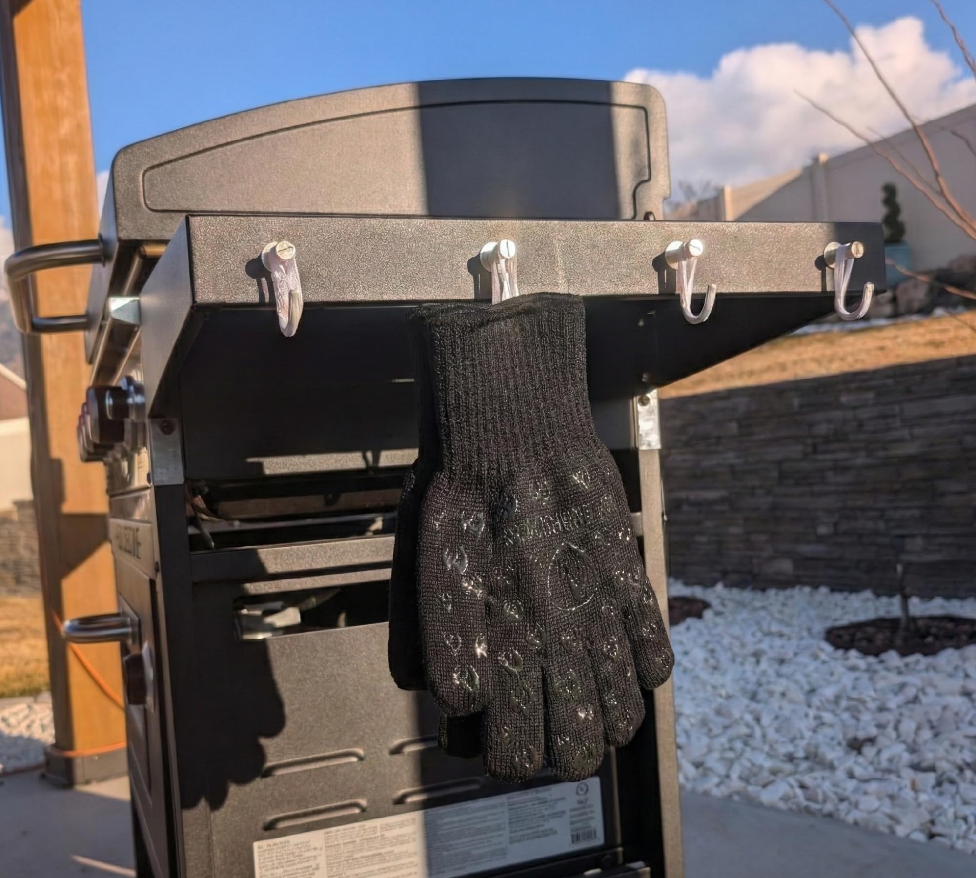 Grill Armor Gloves displayed on a table with BBQ tools