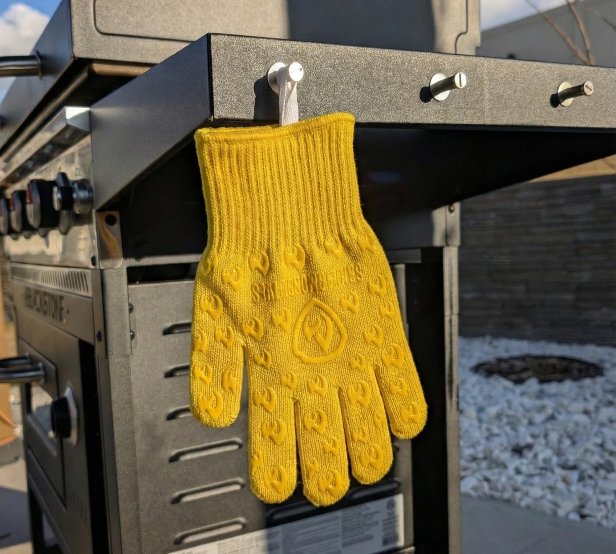 Grill Armor Gloves displayed with BBQ tools