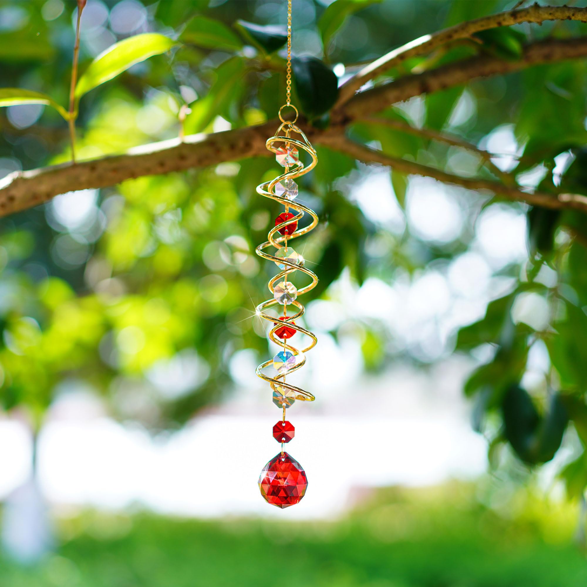 H&D HYALINE & DORA wind spinner with garden flowers in the background