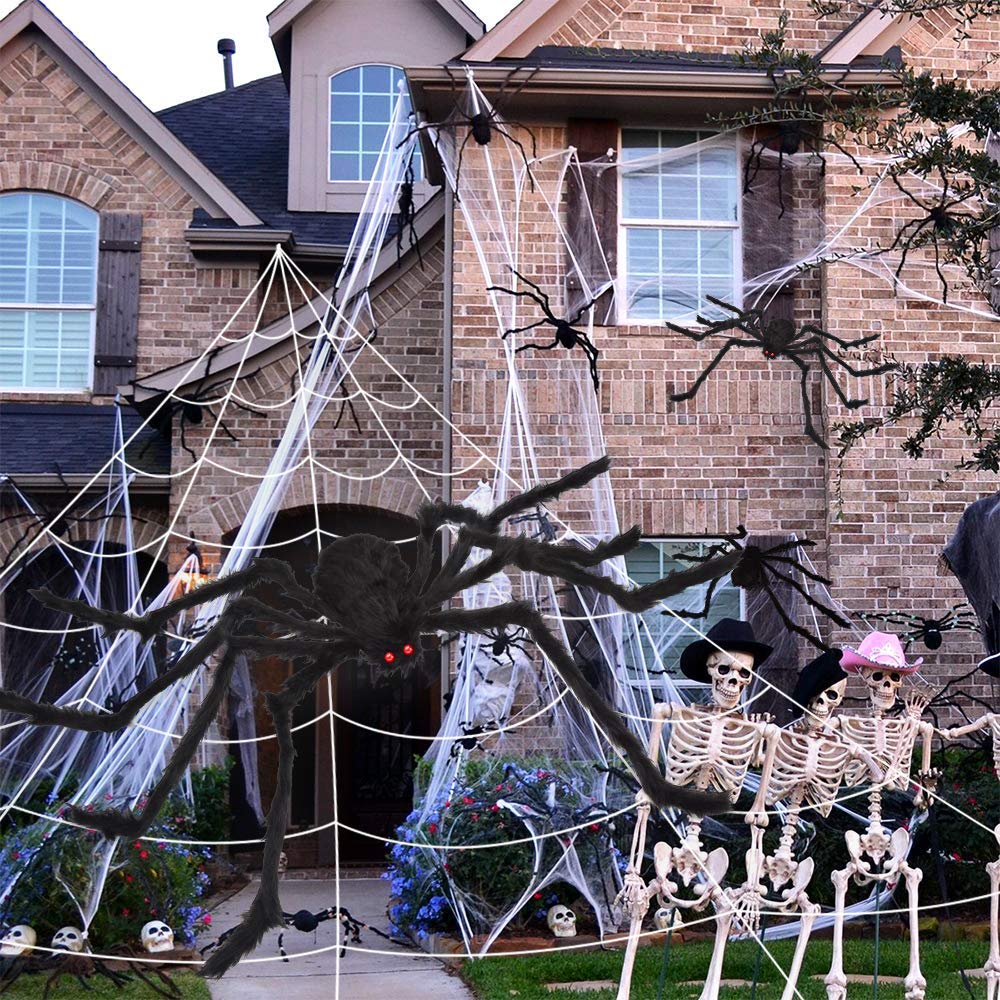 Halloween decorations in a yard with spider web