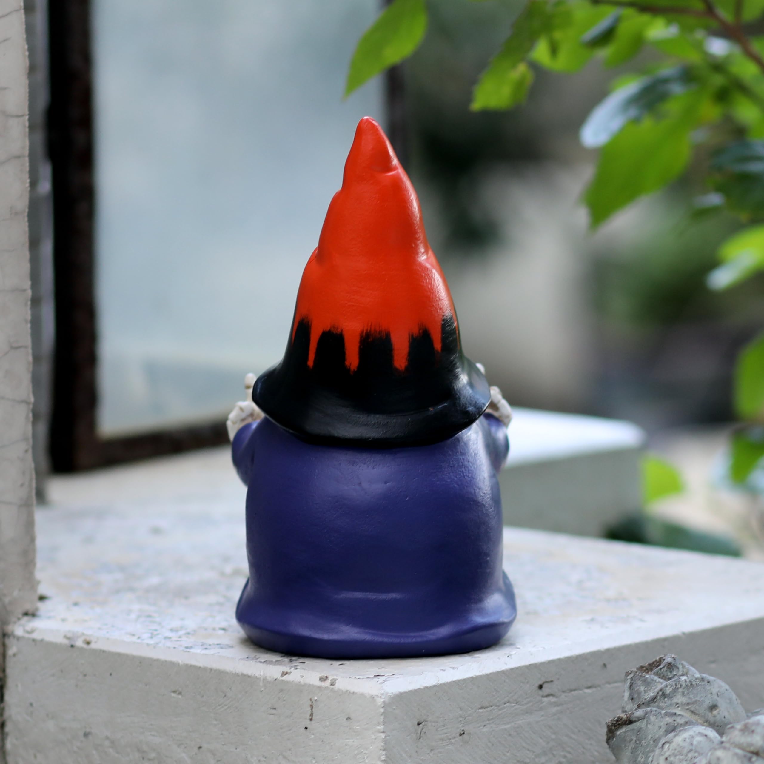 Halloween gnome with spooky decor in the background