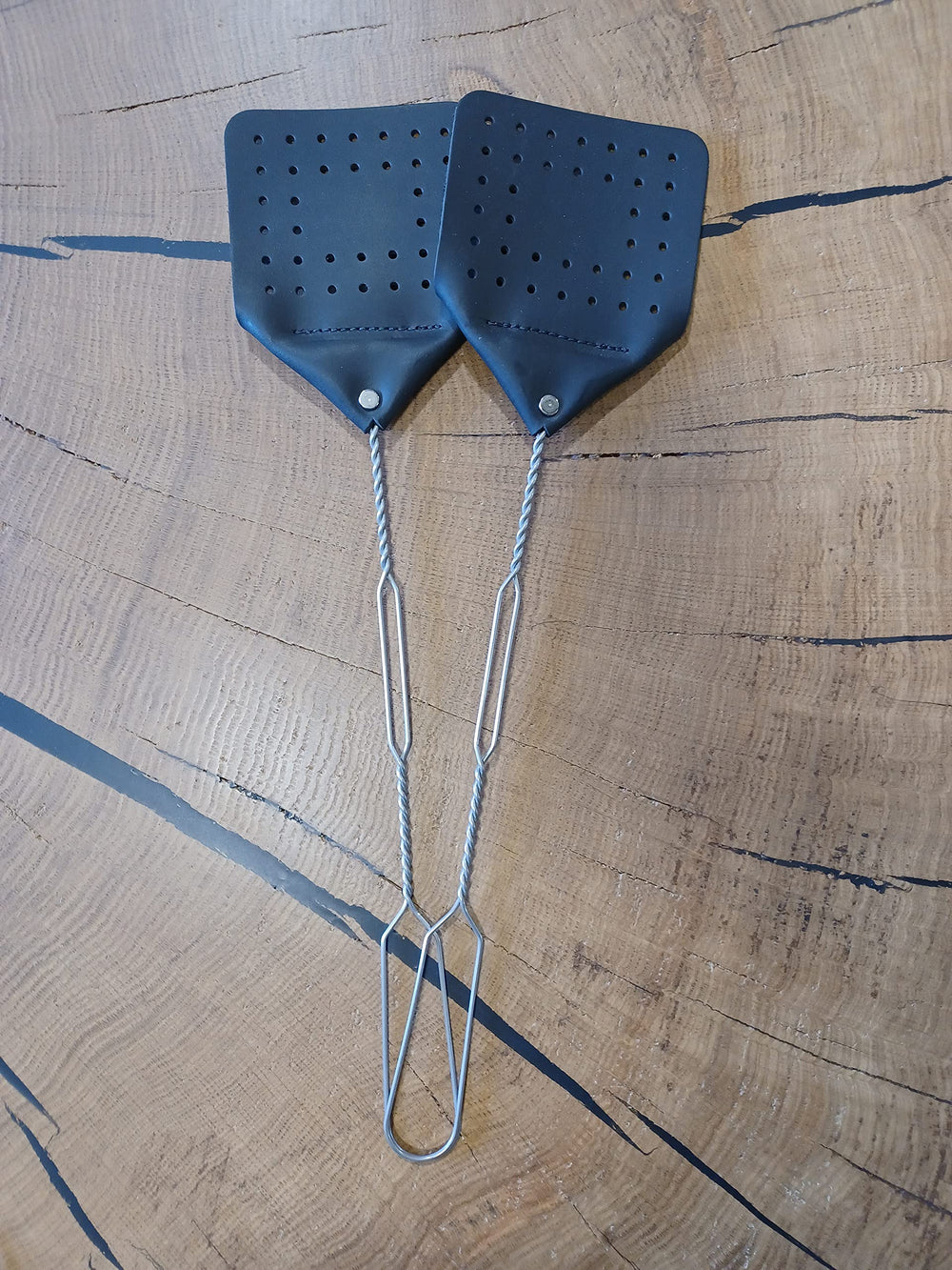Hanging leather fly swatter on the wall