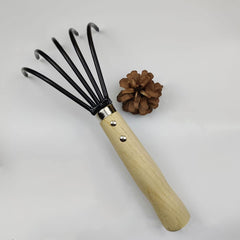 HAOHIYO Ninja Claw Rake on a garden bed