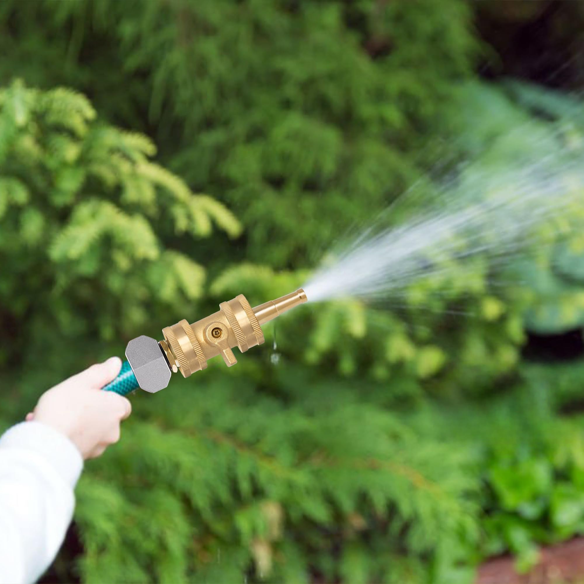 Hourleey hose nozzle in use watering a garden