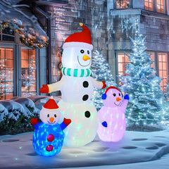 Hourleey inflatable snowman with arms outstretched, glowing at night
