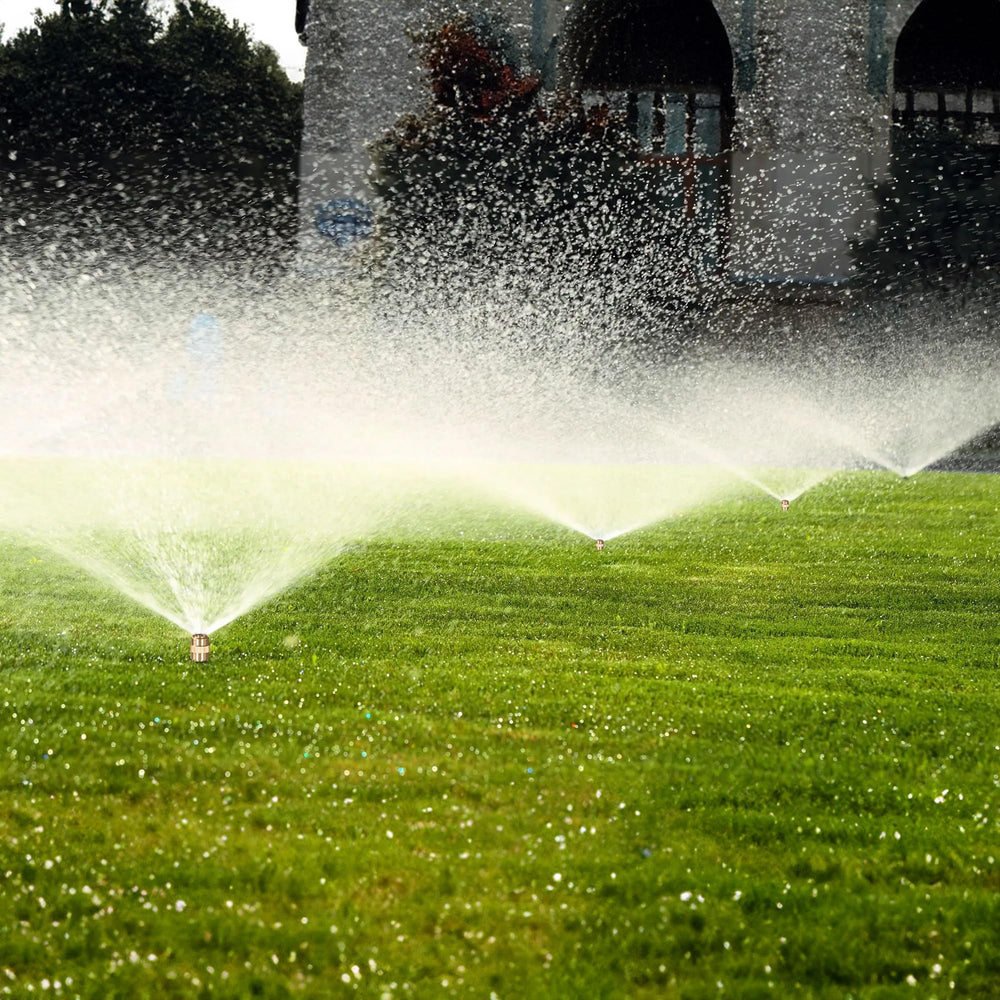 Hourleey Metal Lawn Sprinkler on grass with water spray