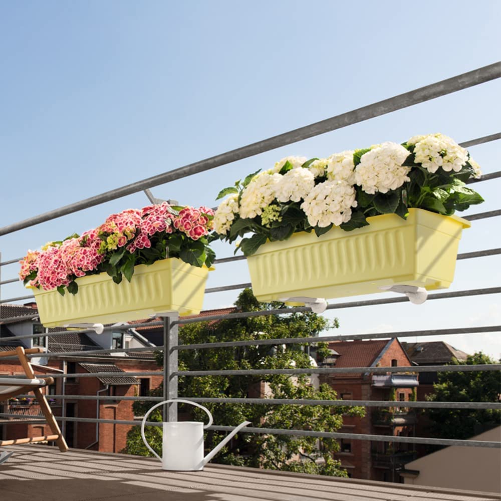 HOXHA planter on a patio with flowers planted