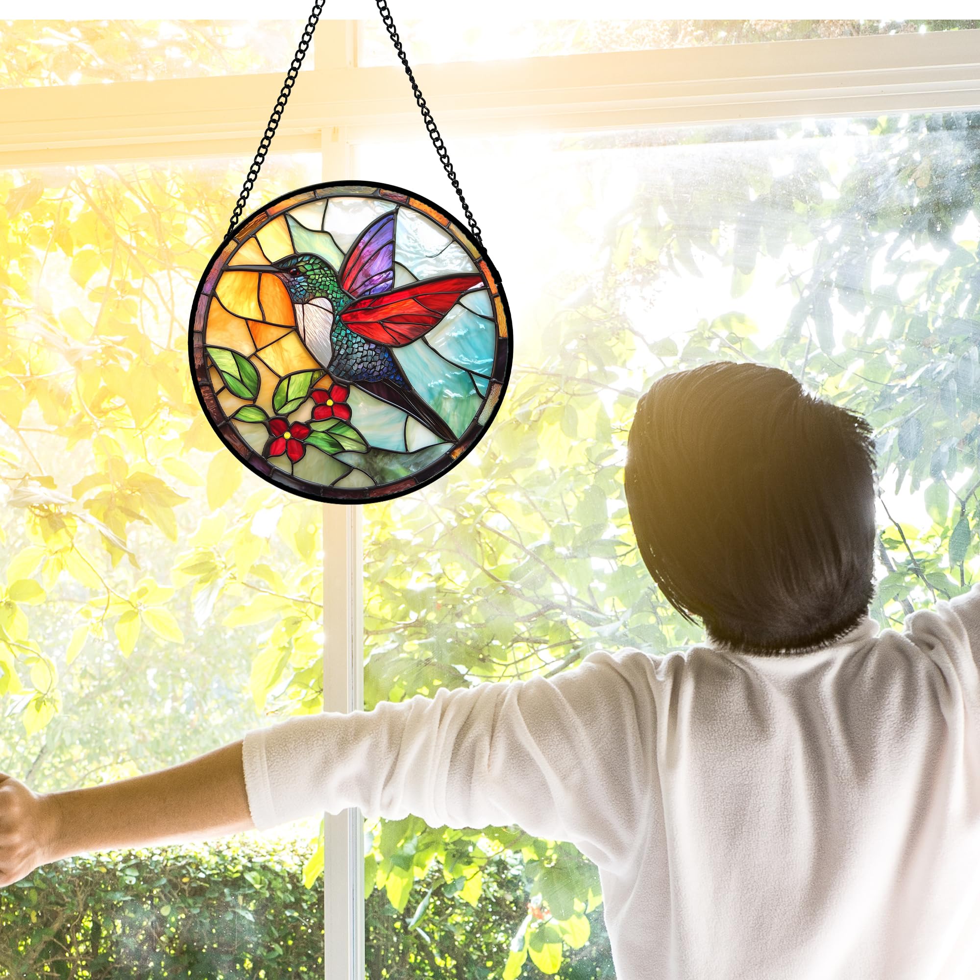 Hummingbird stained glass suncatcher hanging in sunlight