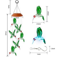 Hummingbird wind chimes with changing colors in garden setting