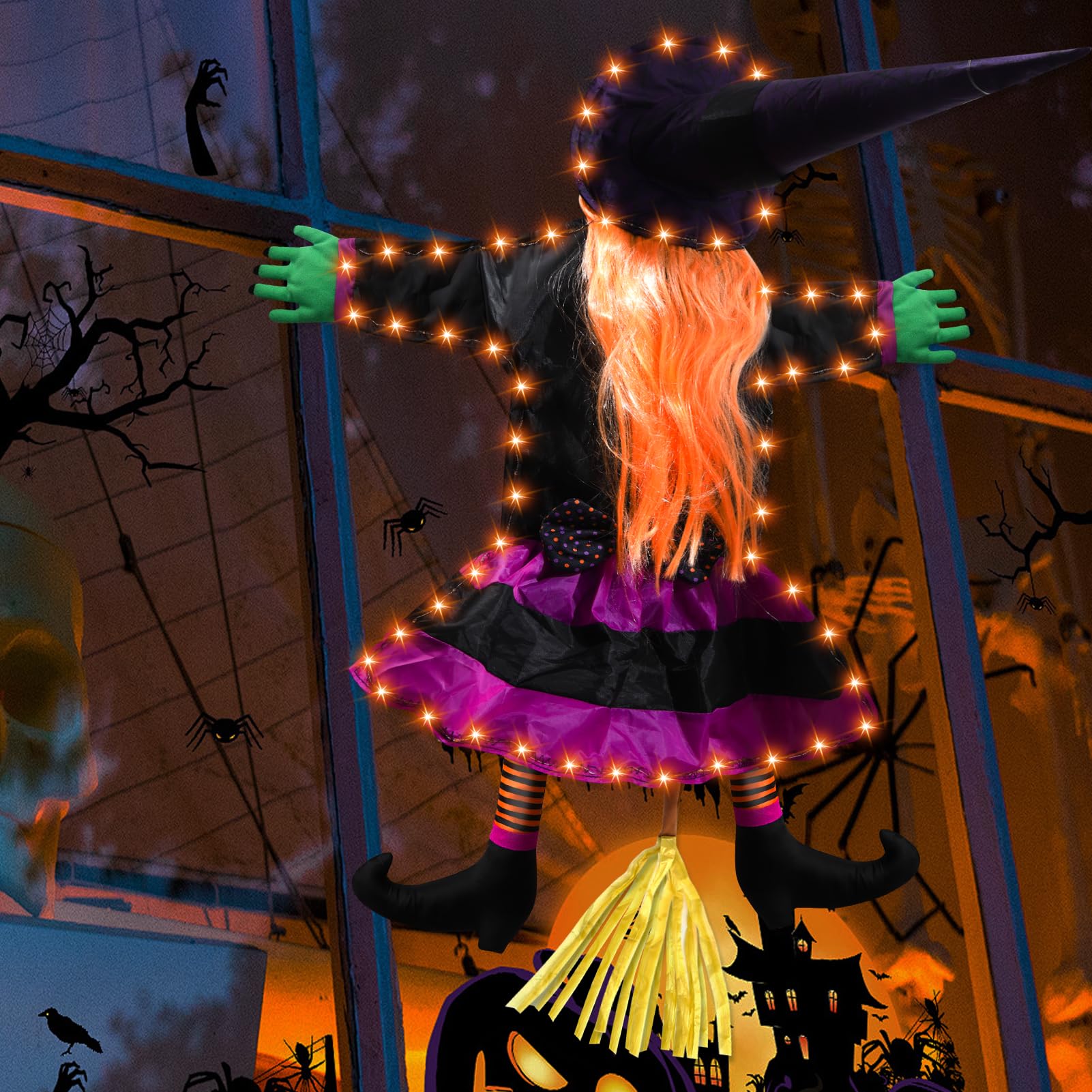 ILLUMINEW witch decoration hanging on a tree