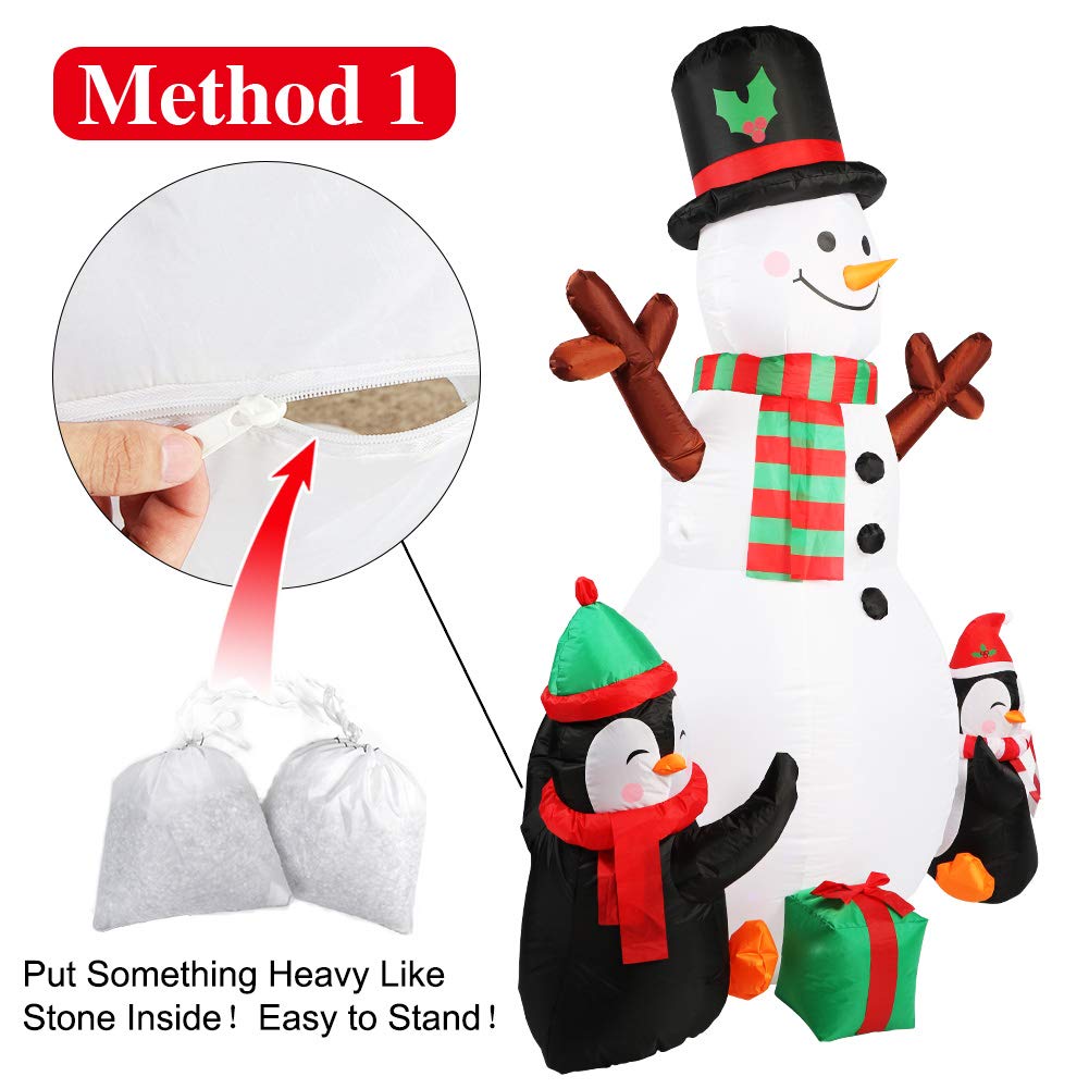Inflatable snowman setup in a festive yard setting