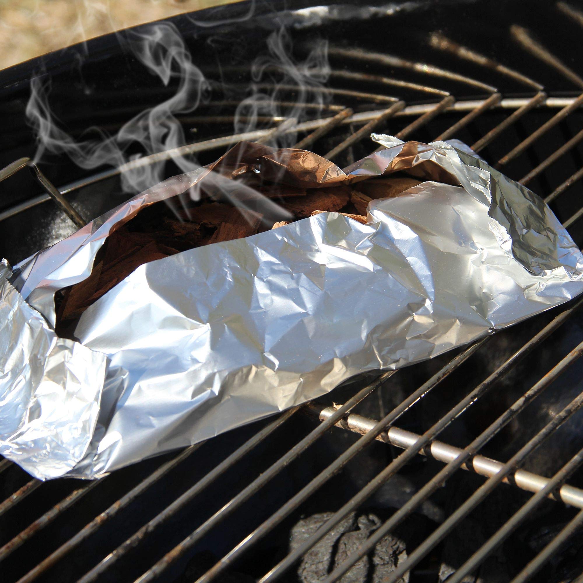 JACKDANIEL'S Wood BBQ Smoking Chips in a grilling setup
