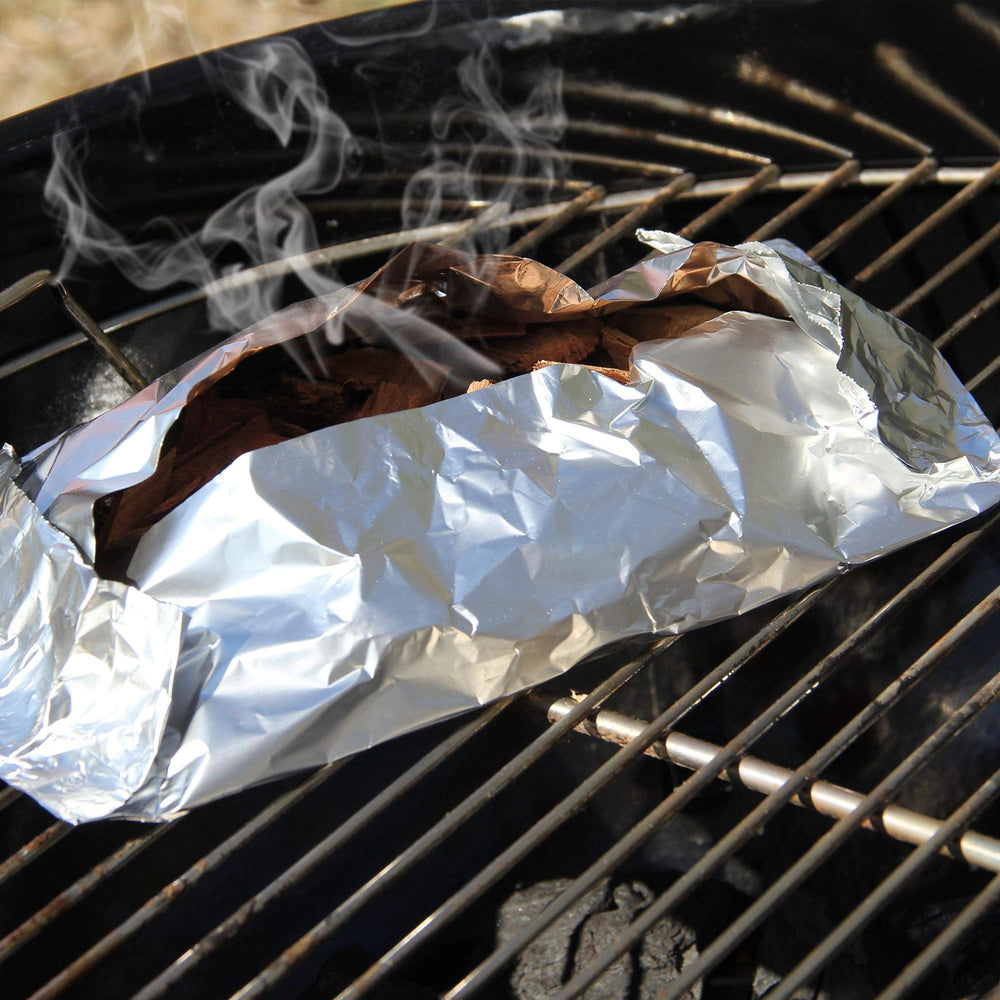 JACKDANIEL'S Wood BBQ Smoking Chips in a grilling setup