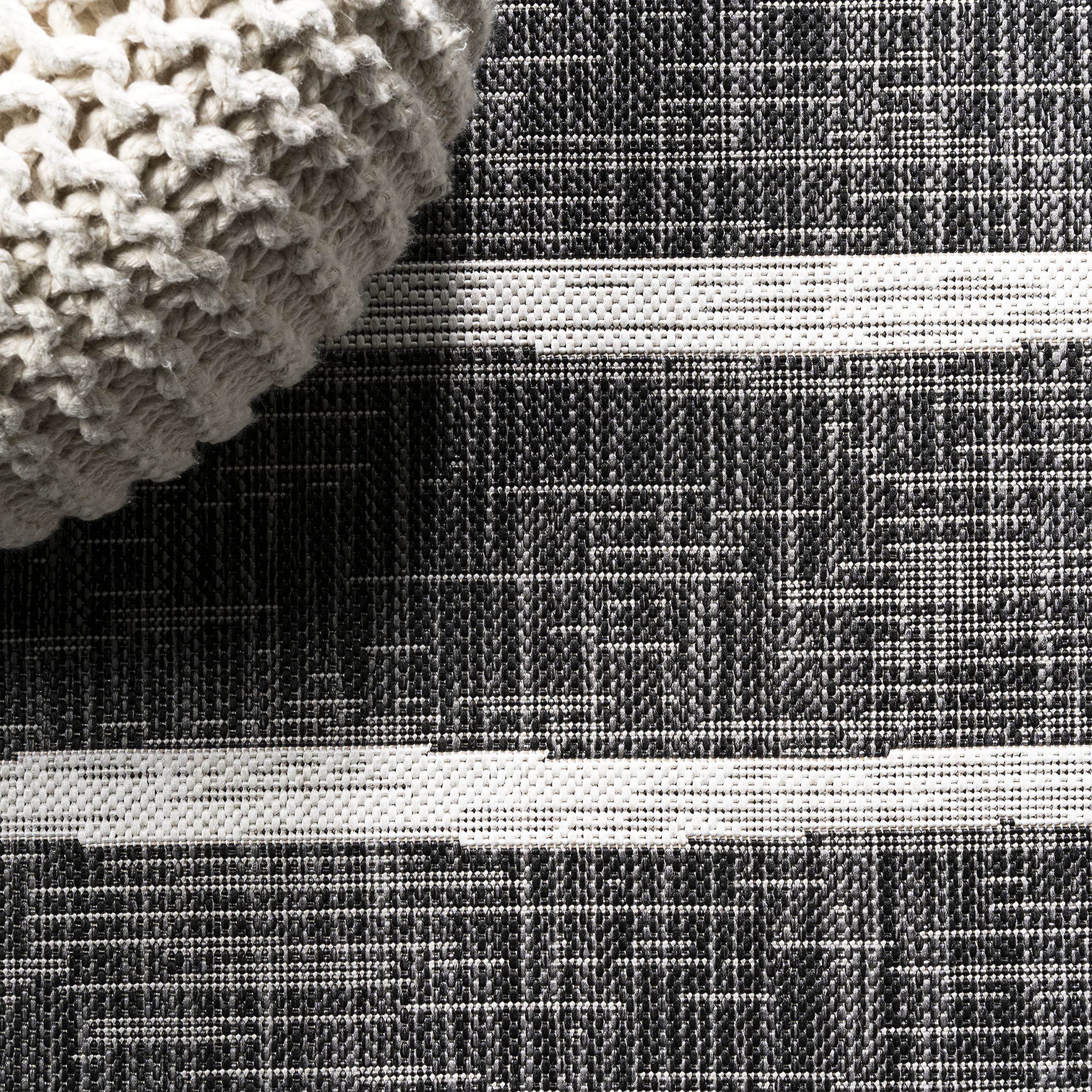 JONATHAN Y Berber Stripe Round Area Rug displayed on patio