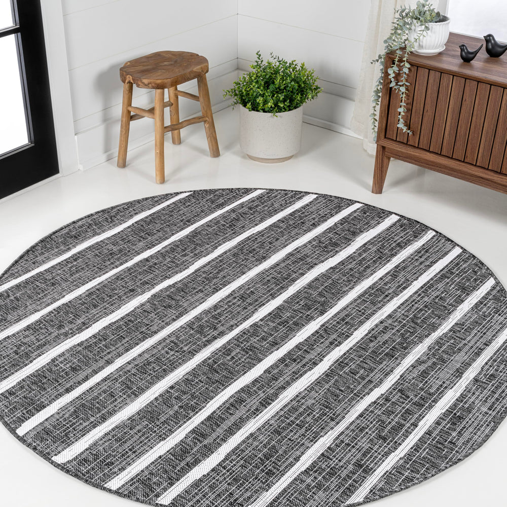 JONATHAN Y Berber Stripe Round Area Rug in outdoor setting