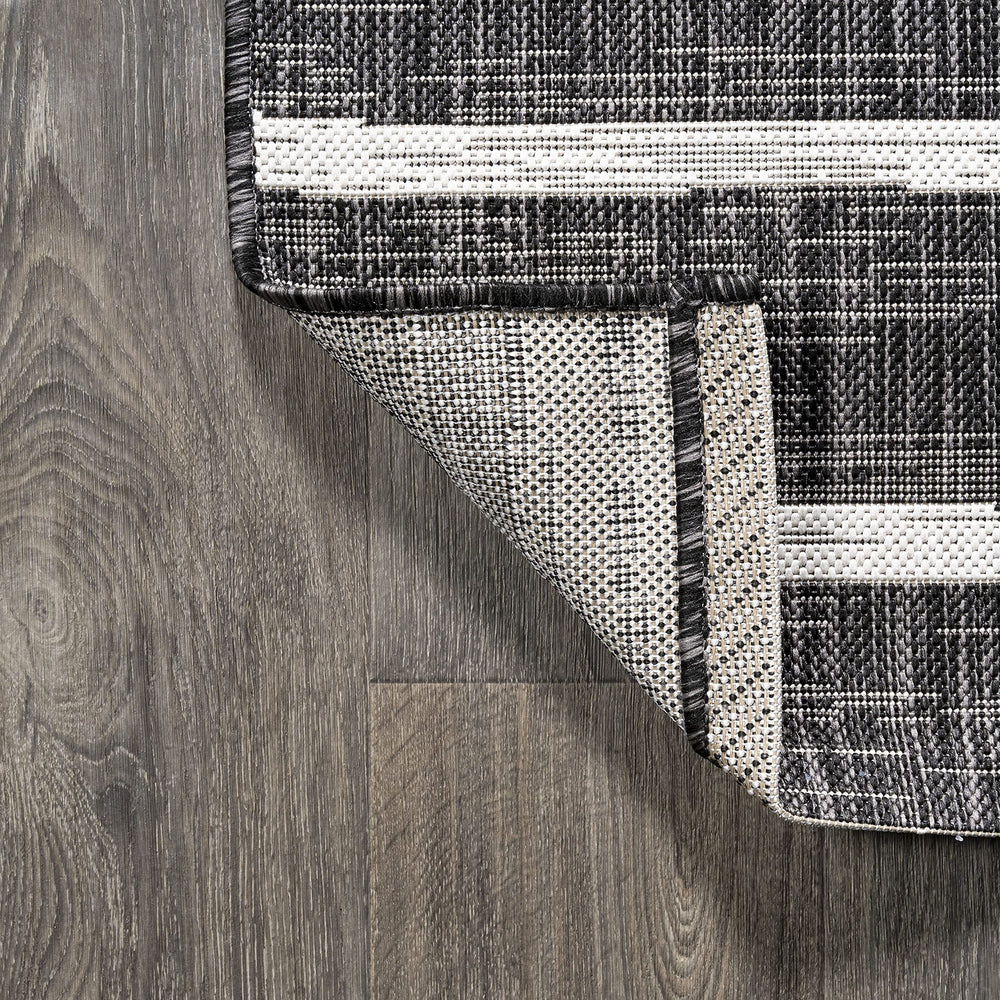 JONATHAN Y Berber Stripe Round Area Rug rolled for storage