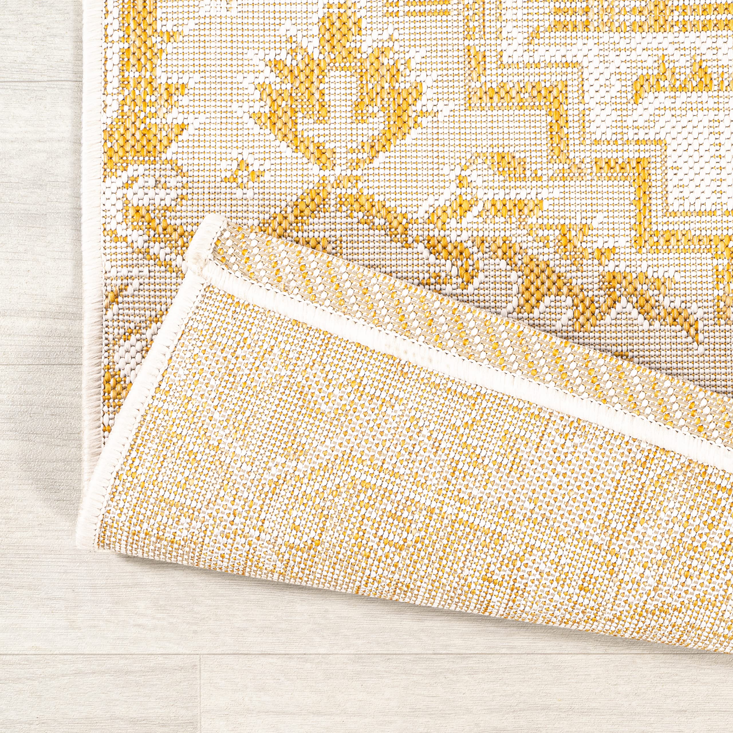 JONATHAN Y Boho Medallion Area Rug in outdoor setting with plants