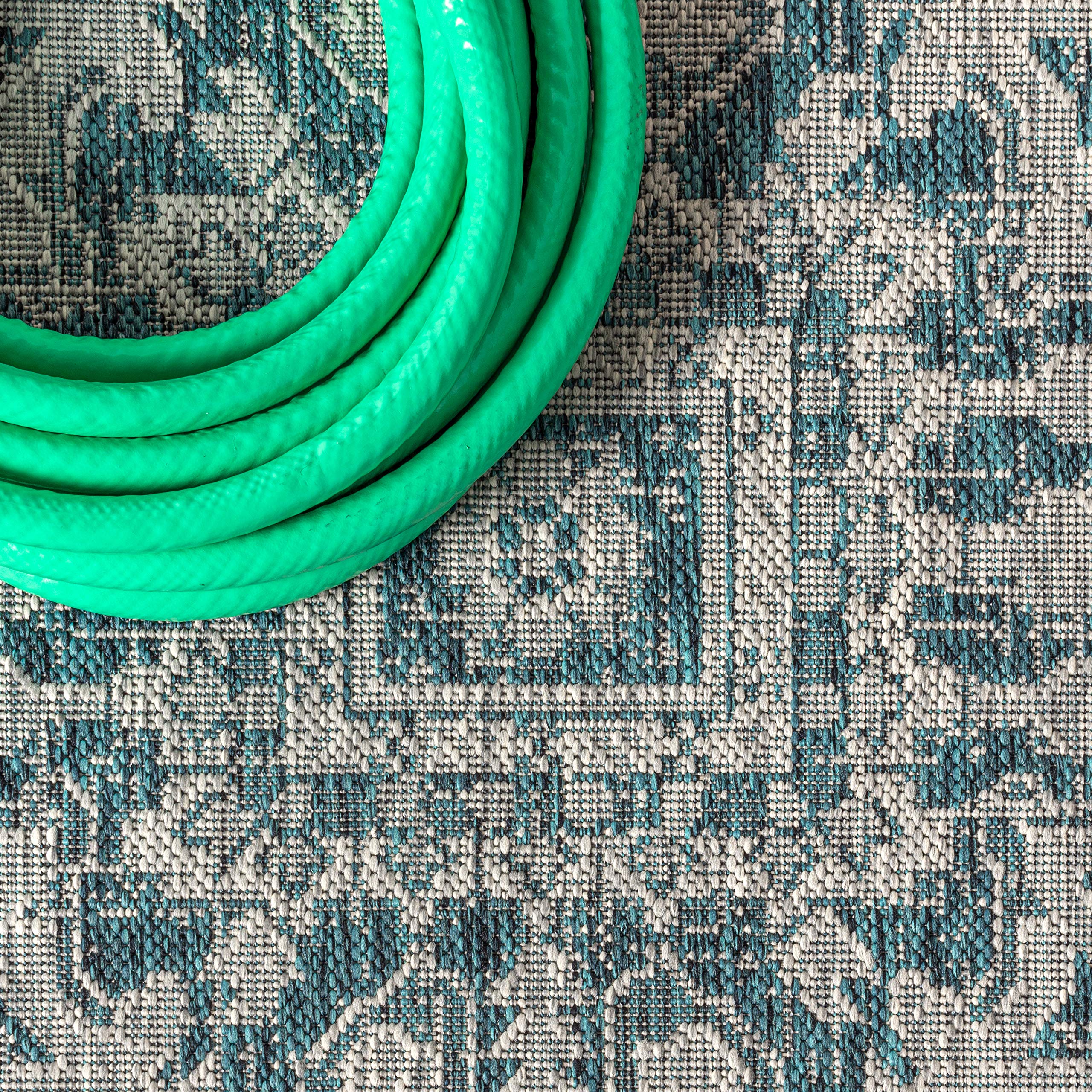 JONATHAN Y Boho Medallion Runner Rug displayed on a patio