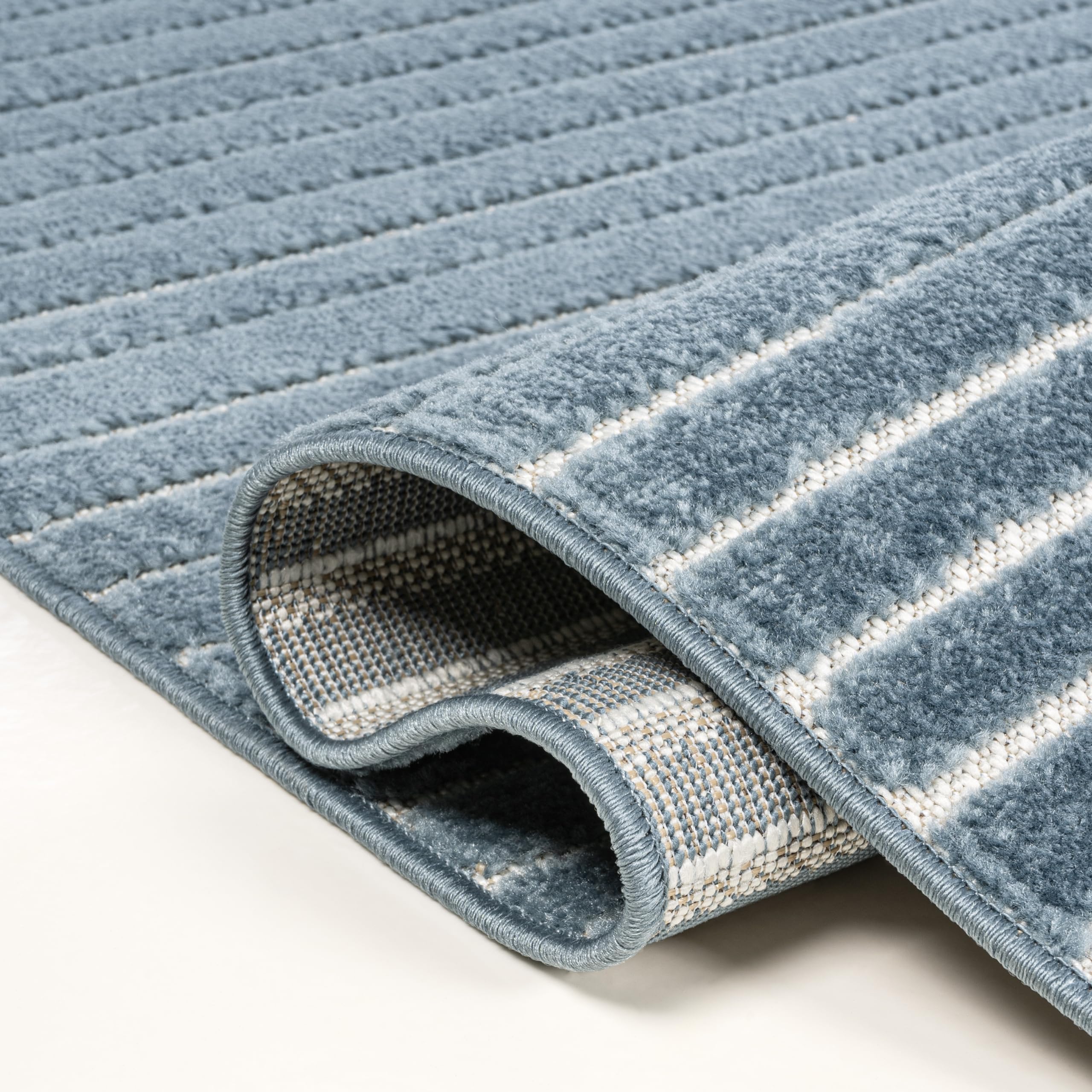 JONATHAN Y Hallie rug rolled up for storage