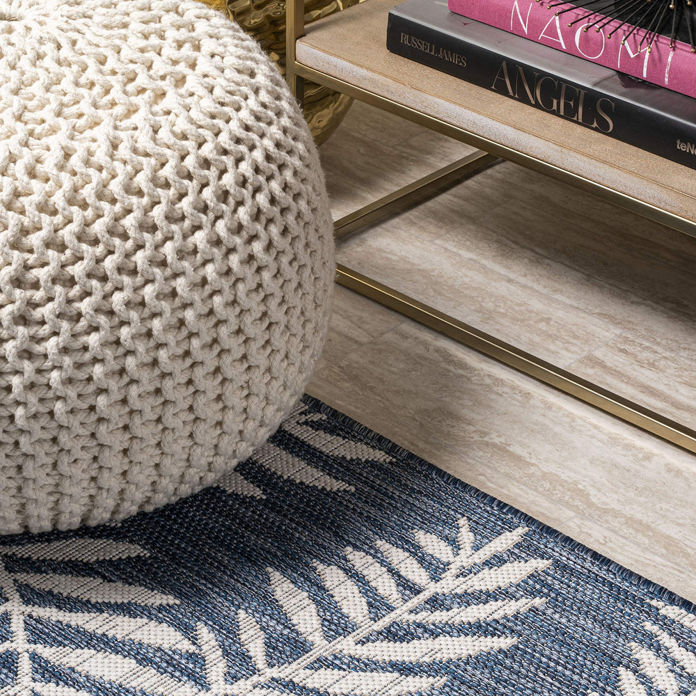 JONATHAN Y Palm Frond Round Area Rug next to furniture