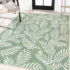 JONATHAN Y Palm Frond Rug on patio setting