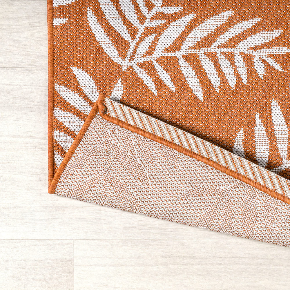 JONATHAN Y Palm Frond Runner Rug displayed on a patio