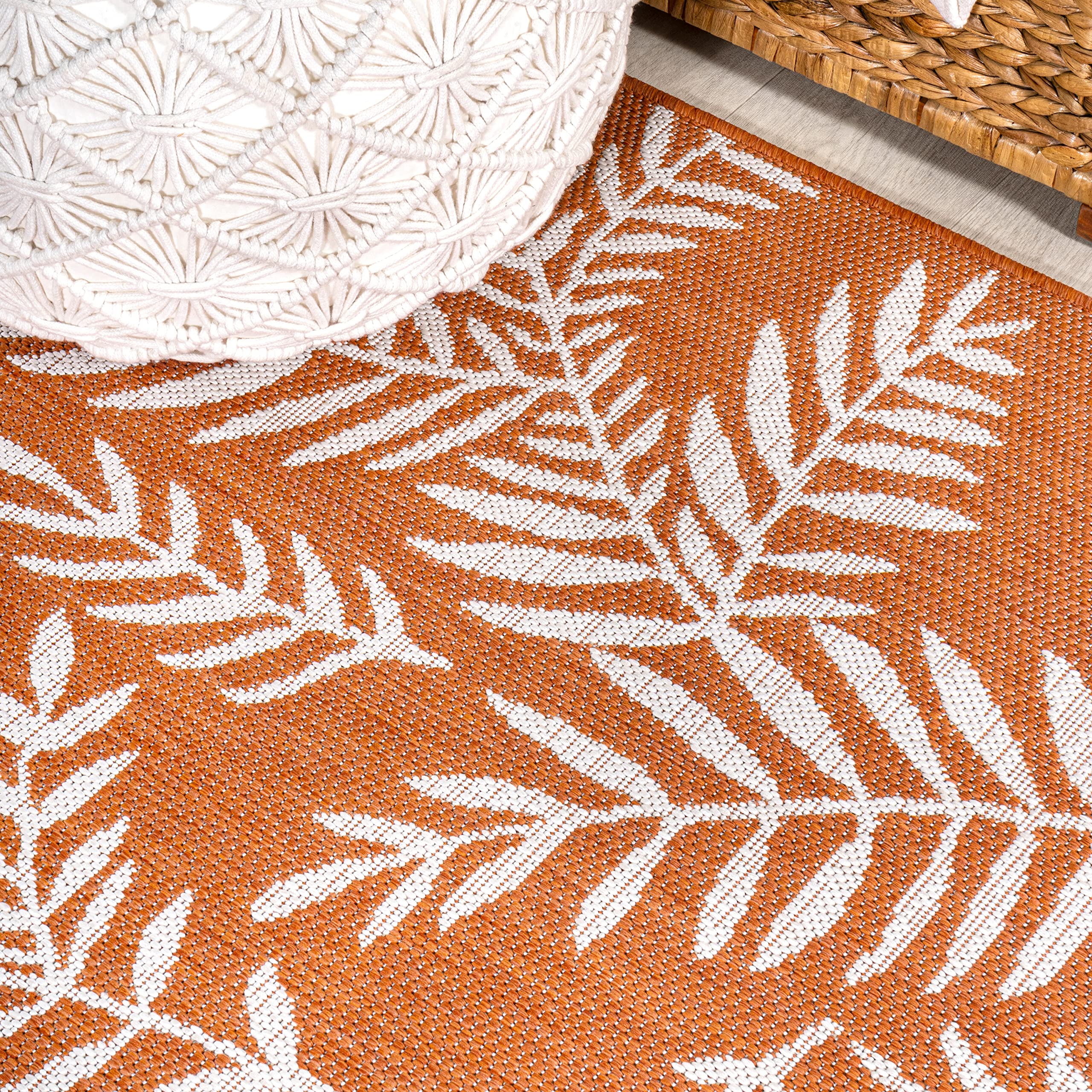 JONATHAN Y Palm Frond Runner Rug rolled up for storage