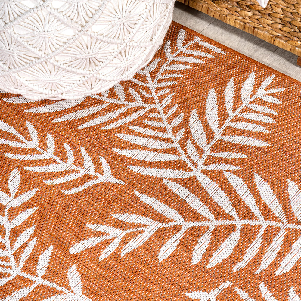 JONATHAN Y Palm Frond Runner Rug rolled up for storage