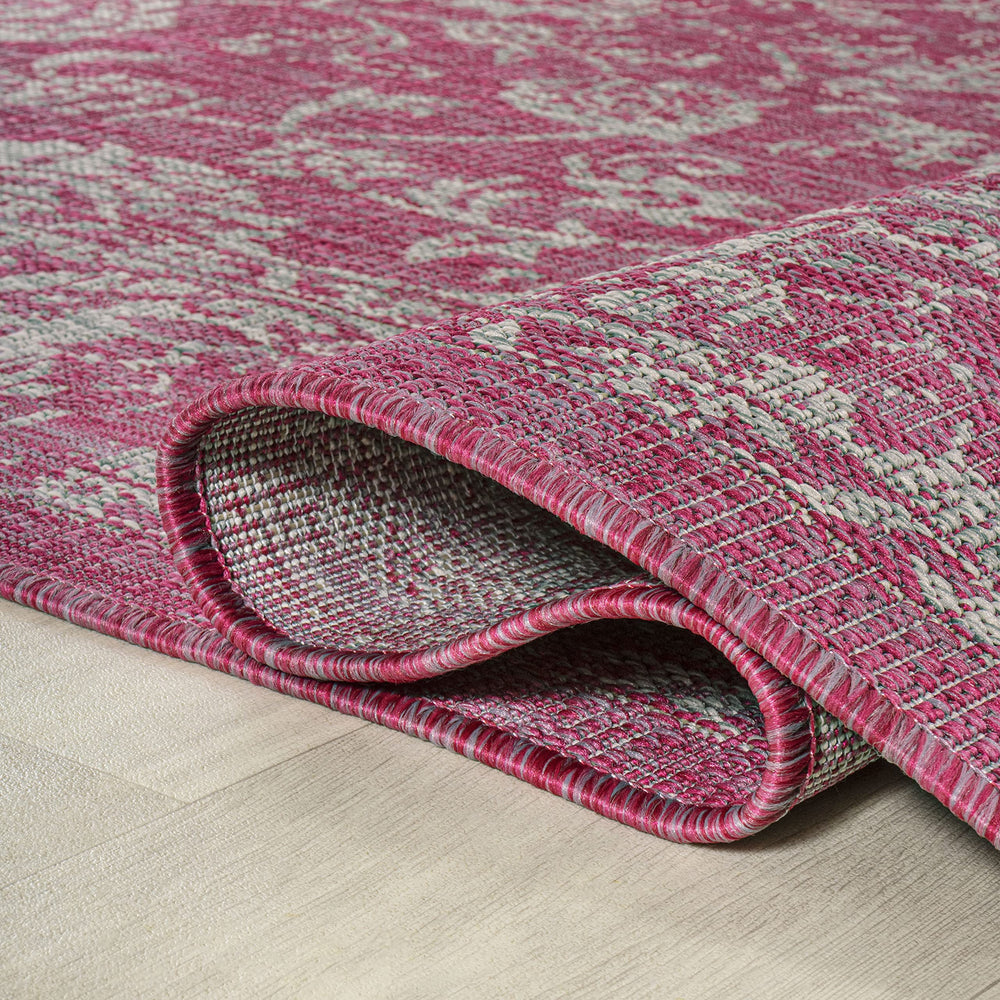 JONATHAN Y Weave Floral Area Rug rolled up for storage