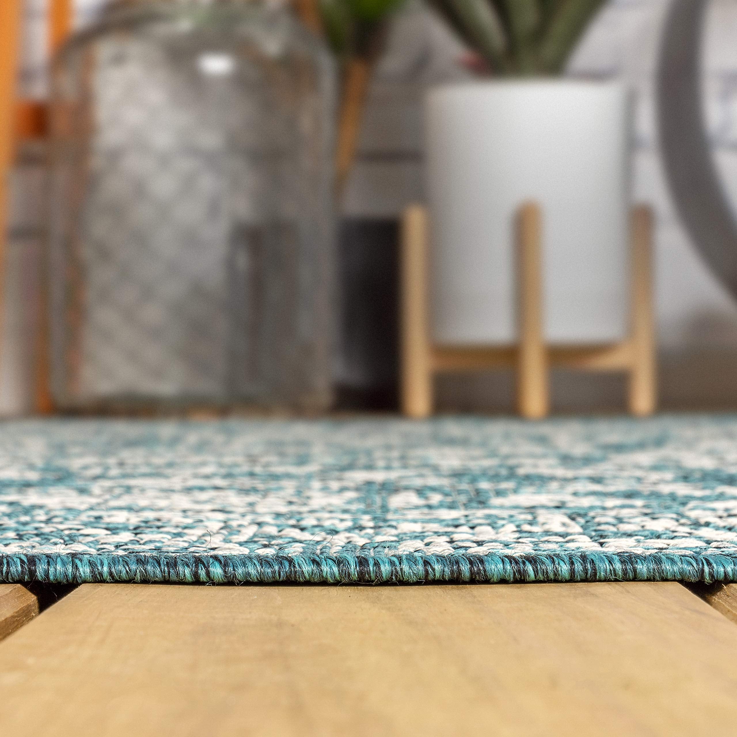 JONATHAN Y Weave Floral Rug rolled up for storage
