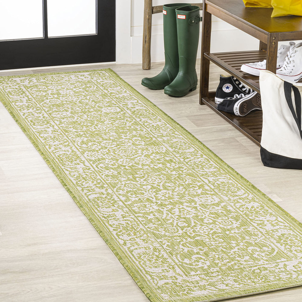 JONATHAN Y Weave Floral Runner Rug displayed on a patio