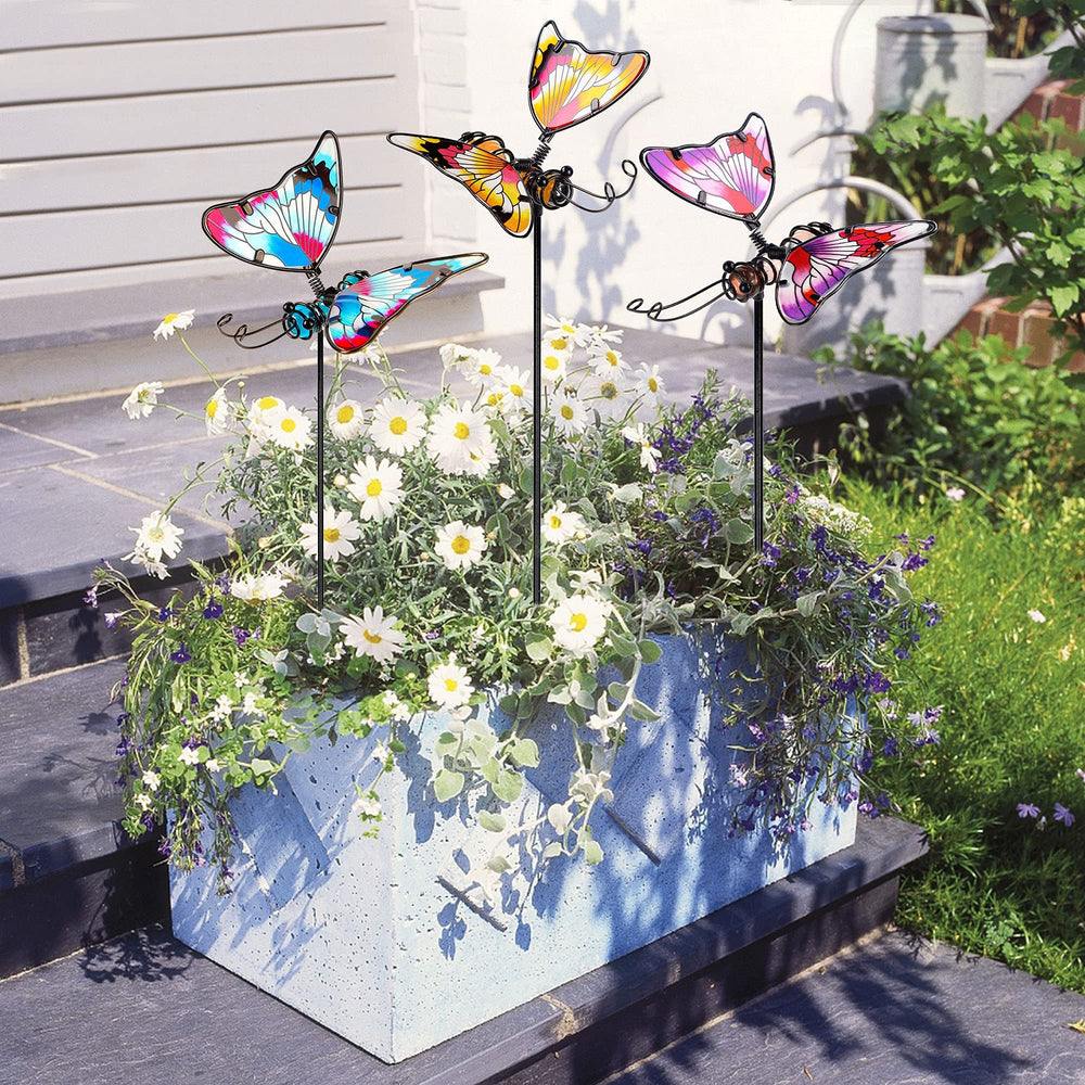 Juegoal decorative garden stakes placed in a flower bed
