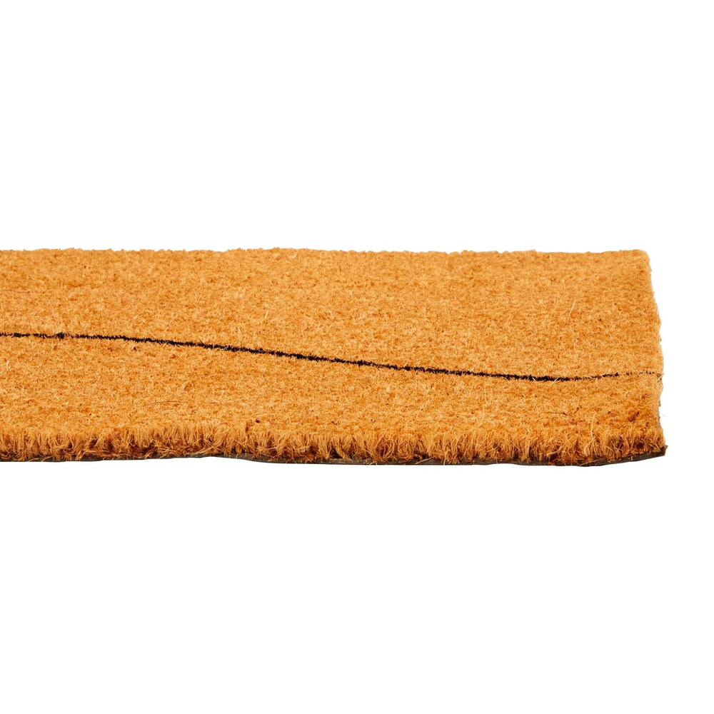 Juvale Coco Coir Door Mat in front of a rustic home
