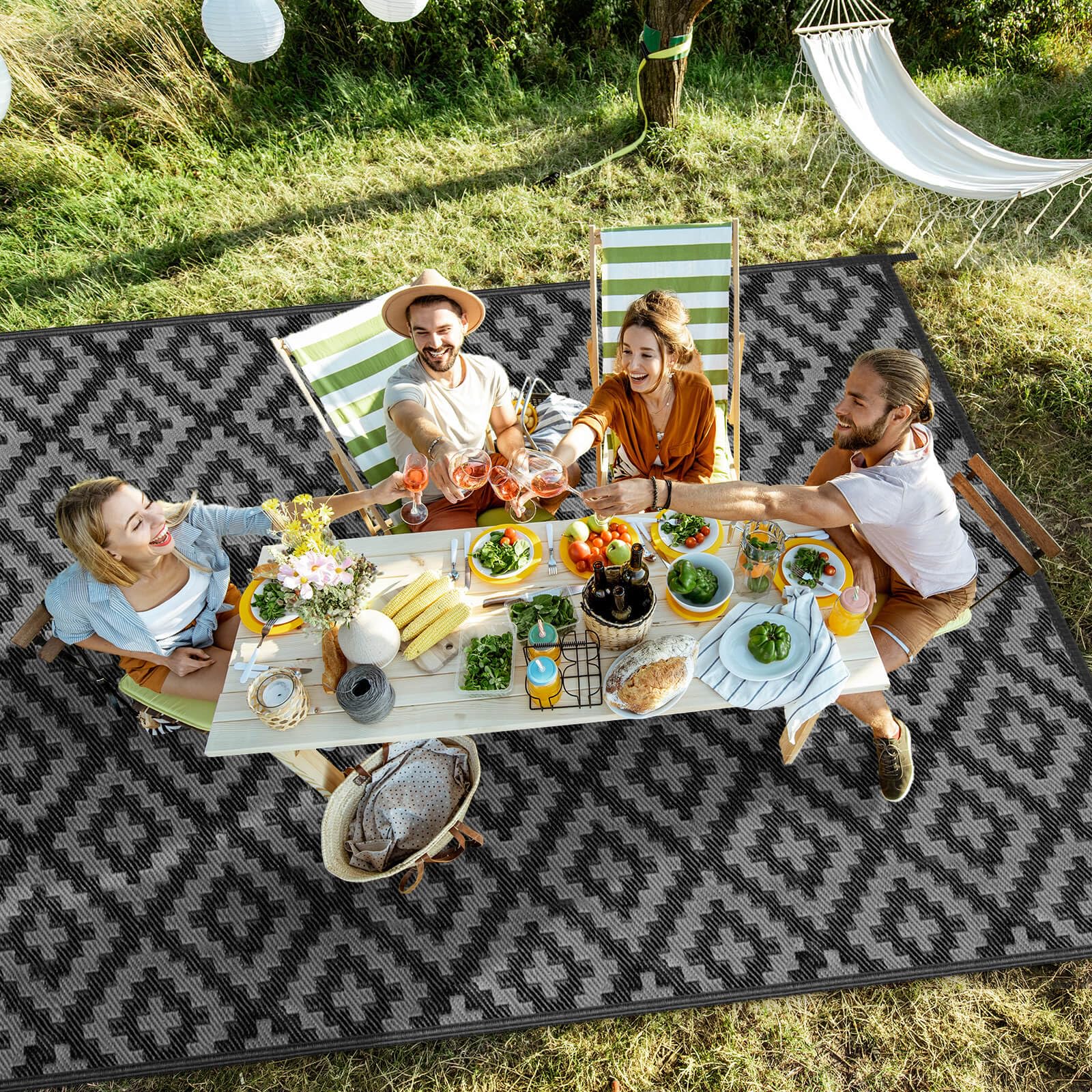 Kalafun Outdoor Patio Rug 6x9 ft rolled up with straps