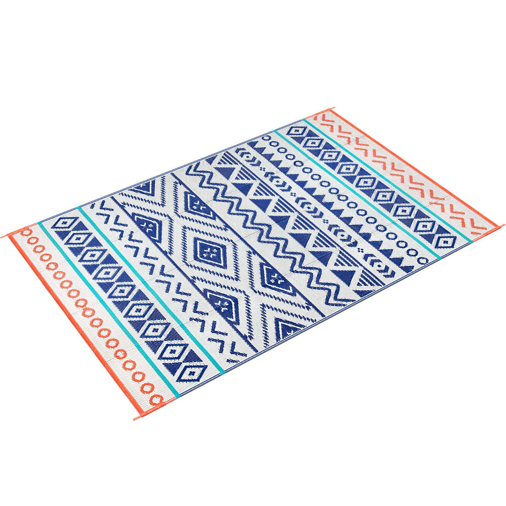 Kalafun patio rug being cleaned with a hose