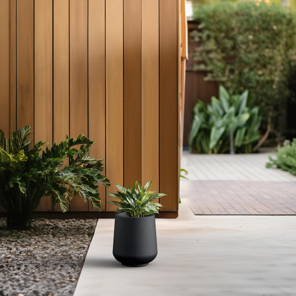 Kante Small Round Black Concrete Planter in outdoor setting