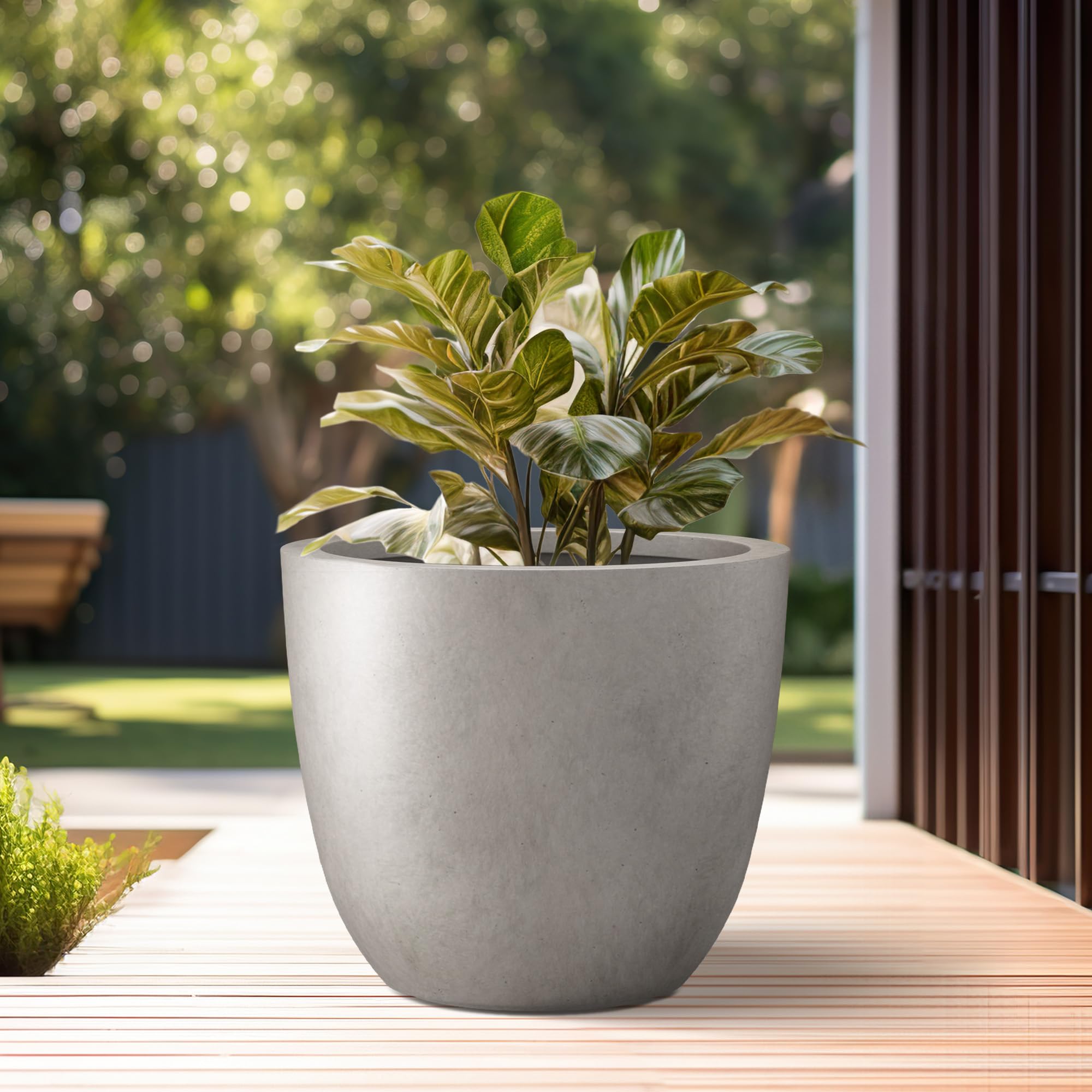 Kante Weathered Concrete Planter on a patio with plants